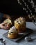 Easter cakes craftily stand on the gray table. The child breaks off a piece. A dark photo.