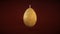 Easter Candle Made of Beeswax in the Shape of an Egg With an Ornament on a Dark Red Background.