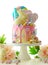 Easter candy land drip cake decorated with lollipops and white bunny.