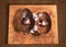 Easter chocolate egg with a surprise of two hearts decorated,sprinkled with cocoa powder and almond blossom.