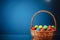 Easter color eggs in festive gift basket, blue background