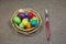 Easter colored eggs in basket on dark green rough cotton texture