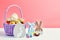 Easter colored eggs in a basket  pink background. Minimal concept. Card with copy space for text. Easter Decoration chick, rabbit