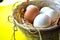 Easter colored eggs in a knitted basket