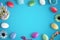 Easter colorful eggs on blue desk. Copy space in the middle for text