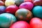 Easter colorful eggs close up. Many colorful holiday eggs are stacked close to each other. Boiled chicken eggs with