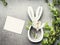 Easter composing with blank white card , spring twigs , flowers and bunny decor