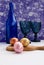 Easter composition. Colored eggs, blue glasses, a bottle of wine on a blue background. Concept. Place for text