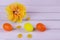Easter composition. Colored yellow eggs and flower on a wooden background. Copy space