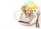 Easter composition. Creative table setting for the holiday of Easter. Flowers in the egg cup on the gray napkin and white plate