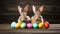 Easter composition with cute rabbits and painted eggs on rustic wooden tabletop