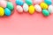 Easter composition. Decorated pastel Easter eggs on pink background top view space for text