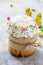 Easter composition. Easter cake decorated white icing and colorful sugar sprinkles