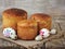 Easter composition of sweet bread, paska and eggs on light wooden background. Orthodox kulich. Holidays breakfast concept with spa