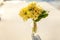 Easter concept. Bouquet of Primrose Primula with yellow flowers in glass vase on white backdrop. Inspirational natural floral