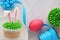 Easter concept with bunny ears cupcakes, blue ribbon, pink egg