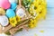 Easter concept. Eggs in a basket decorated with flowers, copy space