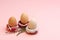 Easter concept. Three donut-shaped handmade ceramic egg holders or cups isolated on pink background.