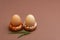 Easter concept. Two donut-shaped handmade ceramic egg holders or cups isolated on brown background