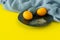 Easter consept in trendy colors illuminating yellow and ultimate gray. Painted eggs on a plate with copyspace