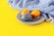 Easter consept in trendy colors illuminating yellow and ultimate gray. Painted eggs on a plate with copyspace