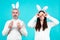 Easter couple. Funny couple wearing bunny ears and having fun with Easter eggs. Friends playing hunt eggs. Happy Easter
