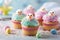 Easter cupcakes with colorful sprinkles on light background, closeup