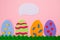 Easter. Cut out the felt applications of four colorful eggs on pink background. Copy space. Flat lay