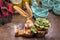 Easter decor and tableware - sleeping ceramic rabbit with fuzzy ears clutches carrot on wooden surface surrounded by bunny bowls