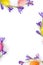 Easter decoration. Easter frame of flowers violet crocuses, colored easter eggs on white background with space for text. Top view