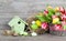 easter decoration with eggs, birdhouse and tulips. wooden background