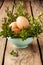 Easter decoration - eggs and buxus on wood