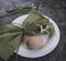 Easter decoration with flowers. Egg on a white plate with a napkin and the first spring flowers of snowdrops