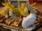 Easter decoration with rabbit, yellow flowers and plates with tasty cake and fruit