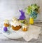 Easter decoration set with glazed kulich and vanilla eclairs