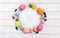 Easter decoration. Wreath of colored easter eggs and quail eggs, flowers cherry tree, hyacinths, muscari with white circle paper