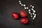 Easter decoration â€“ three colored eggs and willow. Close up, top view, flat lay on dark concrete background