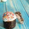 Easter deThe mouse eats an Easter cake on a turquoise wooden table.