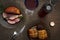 Easter dinner served on burlap tablecloth. Meat, hot cross buns, chocolate eggs and wine