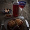 Easter dinner served on burlap tablecloth. Meat, hot cross buns, chocolate eggs and wine