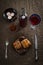 Easter dinner served on burlap tablecloth. Meat, hot cross buns, chocolate eggs and wine