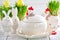 Easter dishes in the form of chickens and rabbits on a white wooden background.