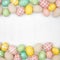 Easter double border with farmhouse style cloth and pastel colored eggs over a white square wood background