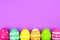 Easter egg bottom border over purple paper background