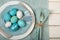 Easter Egg Dinner Place Setting in Nautical Colors of Teal Blue and Off Whites with Plates, Silverware, cloth Napkins and a Name T