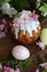 Easter egg in the hands of a child and a cake in sugar icing