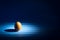 Easter egg minimal concept on a blue background with rays of light. There are morning light on the isolated eggs. An