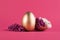 Easter egg painted in gold color decorated with purple lilac floewrs. Happy Easter minimalistic background