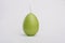 Easter egg shaped green candle with fuse, wick on white background. Easter festive decorations