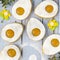 Easter egg-shaped shortbread cookies with apricot jam, sprinkled with powdered sugar.